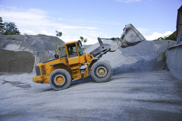Wheel loader Excavator unloading sand during earth moving works