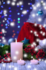 Candles and Christmas decoration on bright background