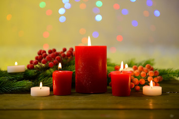 Candles and Christmas decoration on bright background