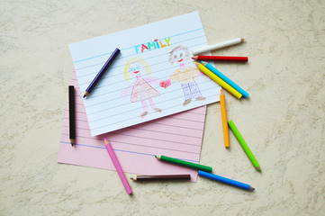 A set of small colored pencils & a drawing about family