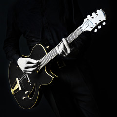 Obraz premium Electric Guitar Guitarist player on black