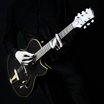 Electric Guitar Guitarist player on black