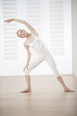 Fototapeta premium young woman practicing exercises easing