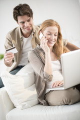 young couple buying online on laptop