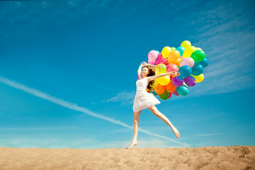 Beauty young stylish woman with multi-colored rainbow balloons i
