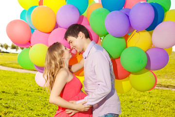 Fototapeta na wymiar Young healthy beauty pregnant woman with her husband and balloon