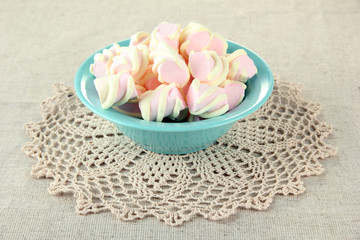 Marshmallows on color plate on light background