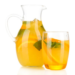Orange lemonade in pitcher and glass isolated on white