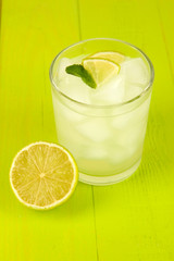 Lemonade in glass on wooden table close-up