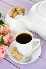 Cup of coffee, teapot and sugar-bowl on color wooden background