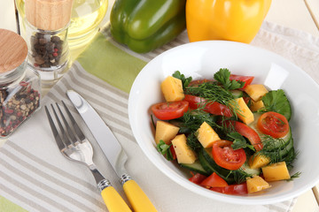 Light salad in plate on wooden table