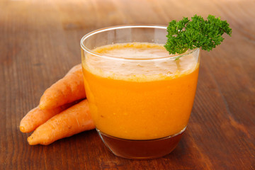Fresh carrot juice on table close-up