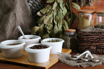 Assortment of spices in  white spoons and bowls,