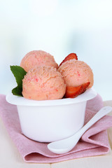 Tasty ice cream scoops in bowl, on table