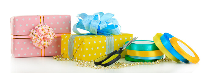 Tapes for wrapping gifts with holiday gifts isolated on white