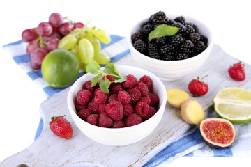 Raspberries and blackberry in small bowls