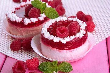 Delicious berry cakes on table close-up