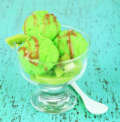 Delicious ice cream on glass vase on wooden table close-up