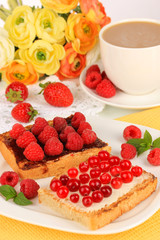 Delicious toast with berries on table close-up