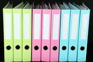 Colorful folders on wooden table, on grey background