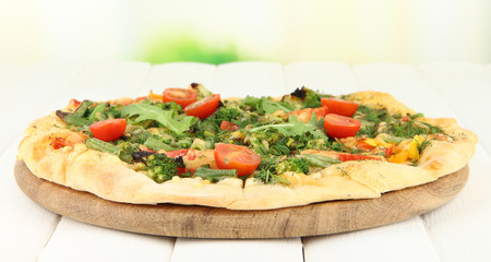 Tasty vegetarian pizza on wooden table