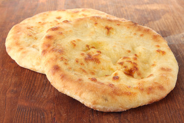 Pita breads on wooden background