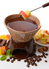 Chocolate fondue with fruits, isolated on white