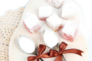 Fototapeta na wymiar Tasty oriental sweets (Turkish delight) with powdered sugar,
