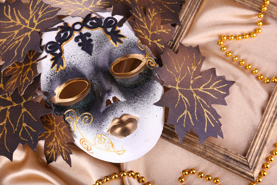 Mask on golden fabric background