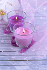 Beautiful colorful candles and  orchid flowers,