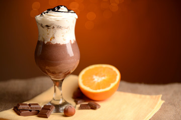 Tasty dessert with chocolate, cream and orange sauce,
