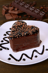 Sweet cake with chocolate on plate on table close-up