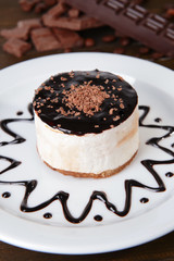 Sweet cake with chocolate on plate on table close-up