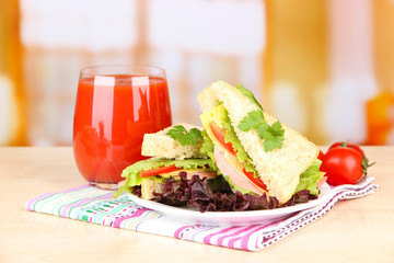 Fresh and tasty sandwiches on plate on table on light