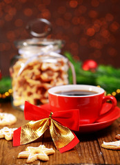Fototapeta na wymiar Delicious Christmas cookies in jar on table on brown background