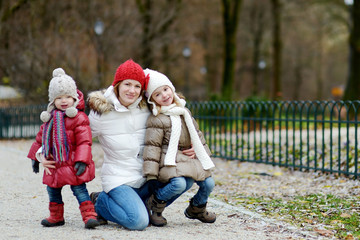 Two sisters and their mom in autumn park