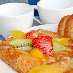 Danish pastry topping with strawberry, kiwi and peach.