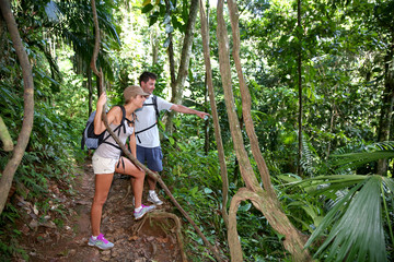Couple on a trekking day in tropical forest