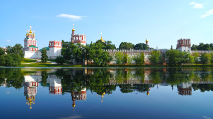 Fototapeta na wymiar Novodevichy Convent and its mirror image on the water surface, M