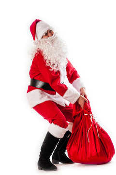 Santa Claus and a heavy bag with gifts
