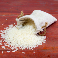 small bag of rice on a wood background