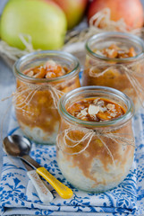 Milk-rice dessert with caramelized apples in glass jar