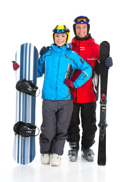 Happy smiling attractive couple of snowboarder and ski rider.