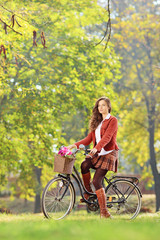 Fototapeta na wymiar Beautiful female on a bicycle in a park
