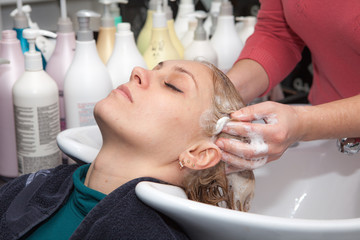 Obraz na płótnie Canvas hair washing at a hairdressing salon, young caucasian girl