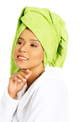 Portrait of attractive woman wrapped in towel with turban on hea