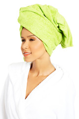 Portrait of attractive woman wrapped in towel with turban on hea