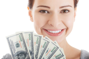 Young beautiful casual woman holding large sum of money.