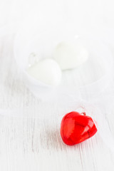 Romantic background with glass hearts in red and white