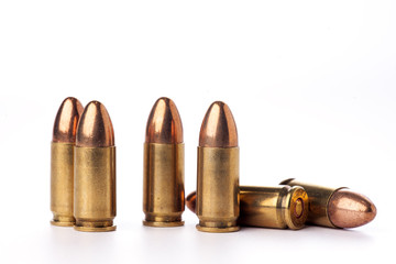A group of 9mm bullets for a a gun isolated on white - obrazy, fototapety, plakaty